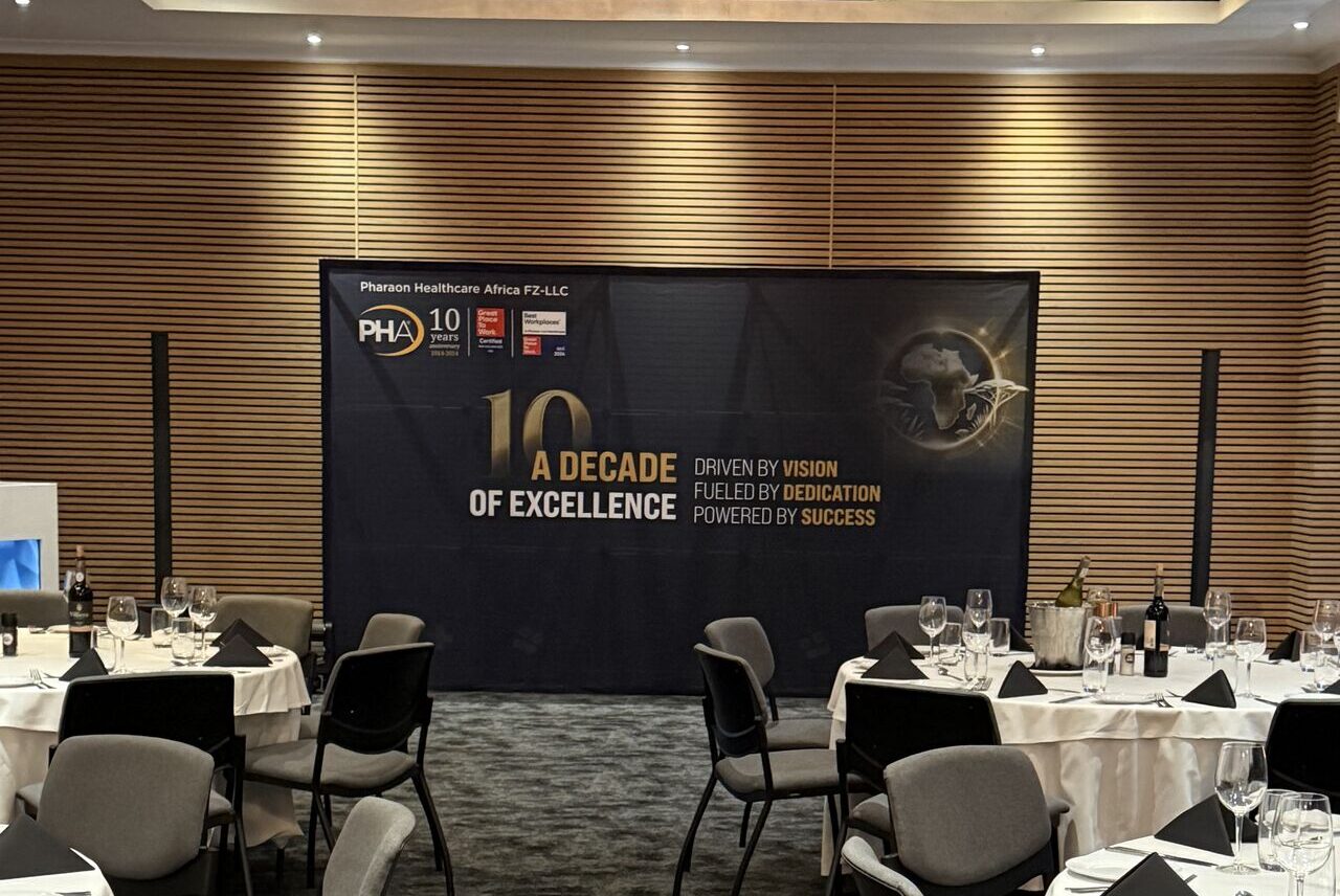 Healthcare conference organized by Travel Story in Cape Town South Africa with branded event backdrop and formal dinner setup