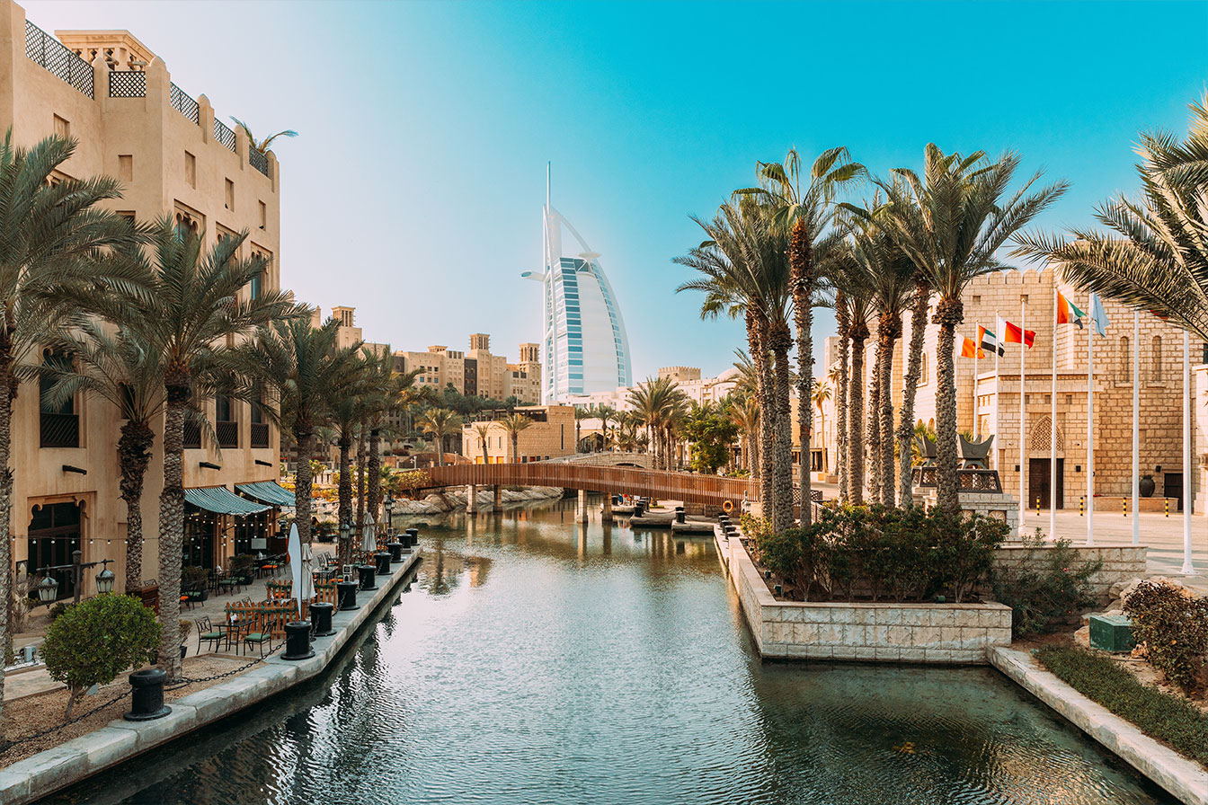 Madinat Jumeirah resort with traditional architecture and Burj Al Arab in the background