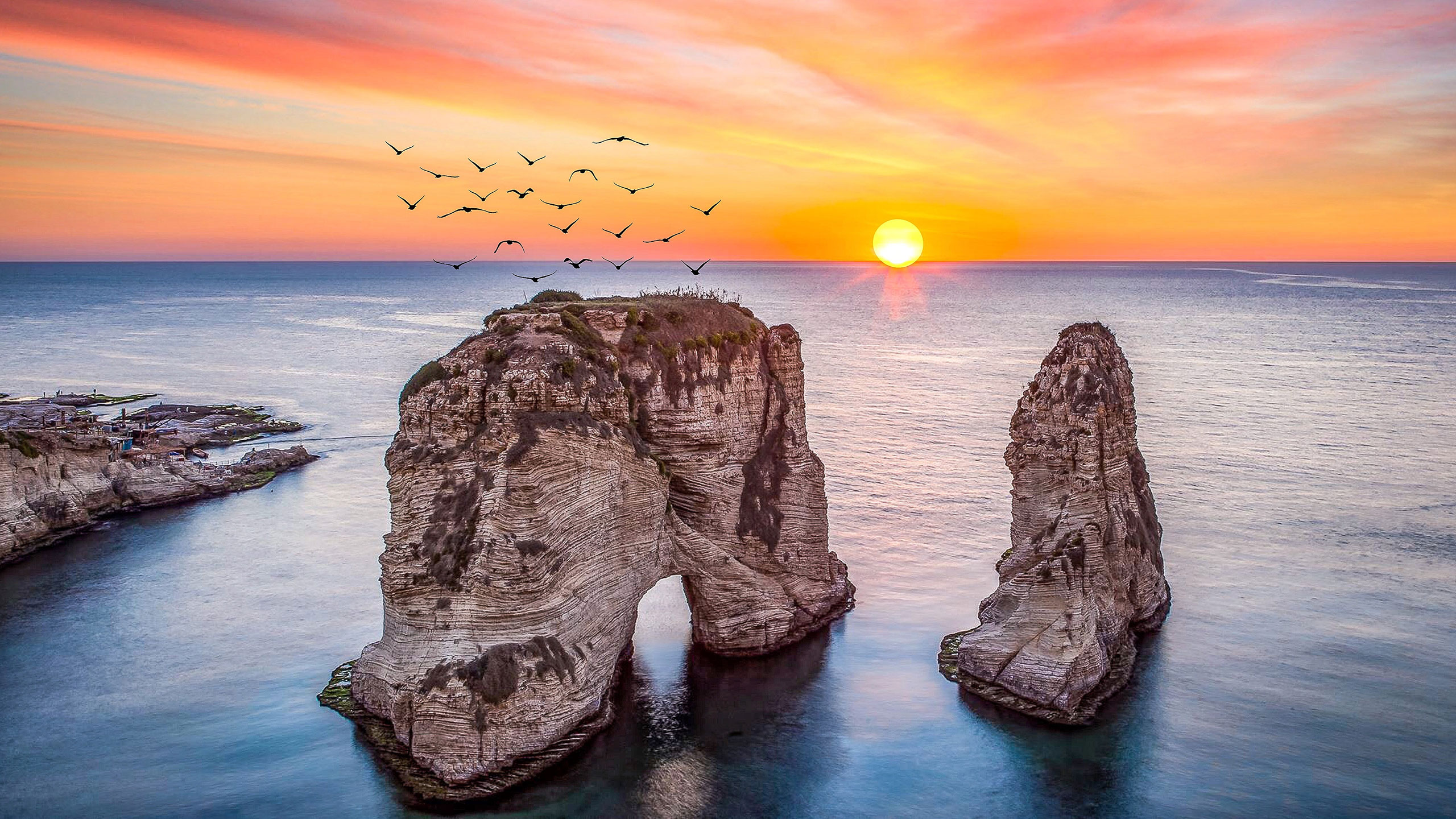 Raouché Rocks at sunset in Beirut with Mediterranean coastline and city skyline