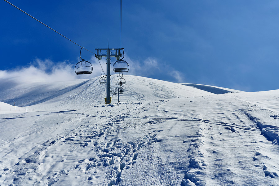 Ski slopes in Mzaar with ski lift and snow-covered mountain peaks in Lebanon